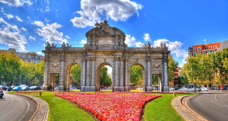 Puerta de Alcalá in Madrid surrounded by colorful flowers
