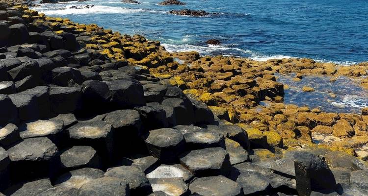 Giant's Causeway hexagonal basalt columns by the sea.