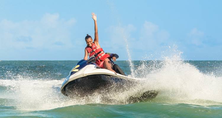 Person riding a jet ski on the ocean with waves.