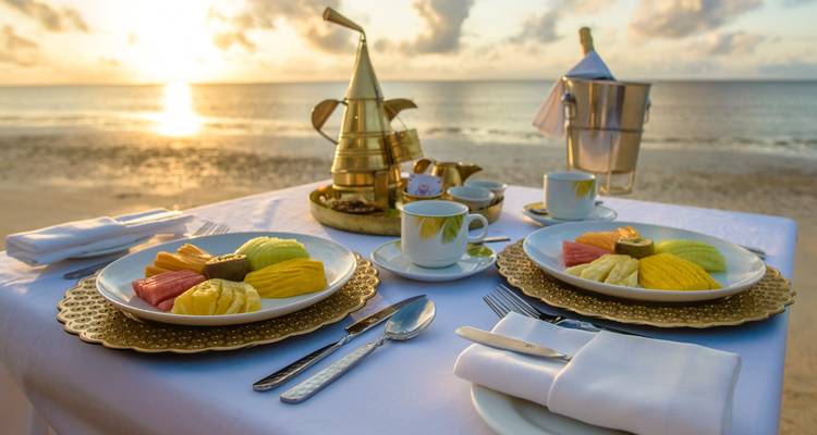 Breakfast setup with a view of the ocean at sunrise.