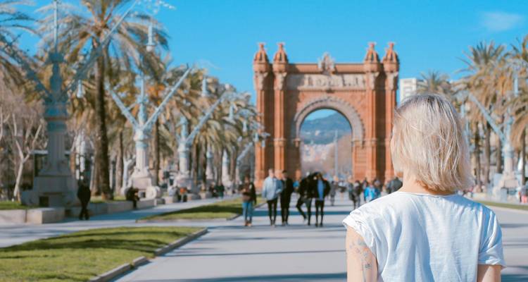 Arc de Triomf in Barcelona, Spain with people strolling down the promenade.