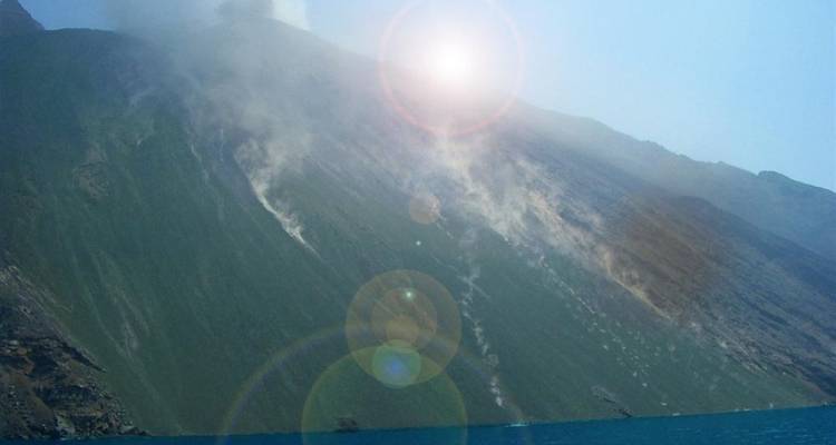 A mountain landscape with smoke and lens flare.