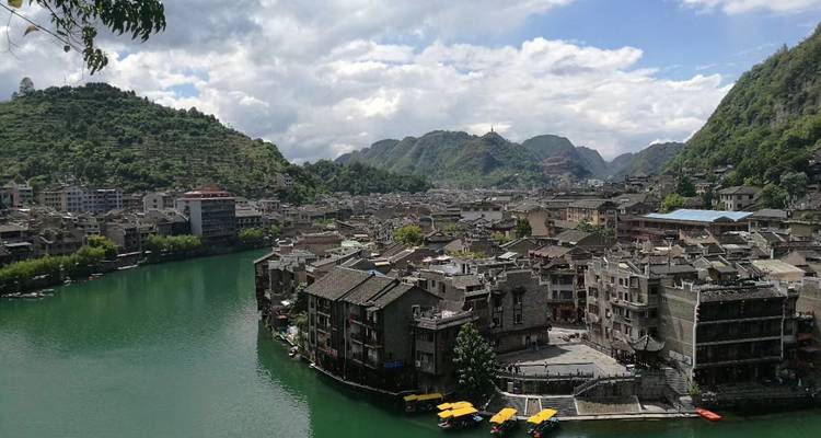 Cityscape along a river in a mountainous region