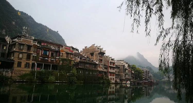 Misty town by a river surrounded by mountains