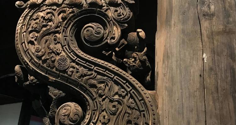 Intricate wooden carving on a pillar.