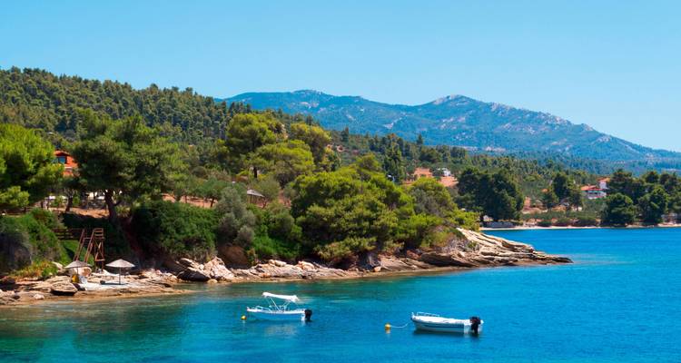 A coastal area with boats and turquoise water.