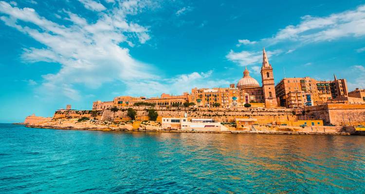 Historic coastal cityscape of Valletta overlooking blue waters.