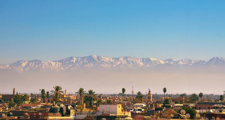 City view with mountains in the background, clear sky.