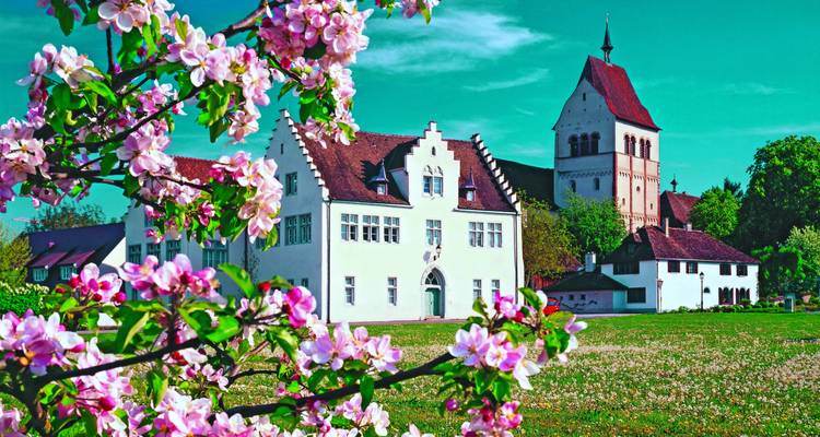 Historic building with blooming flowers in the foreground.