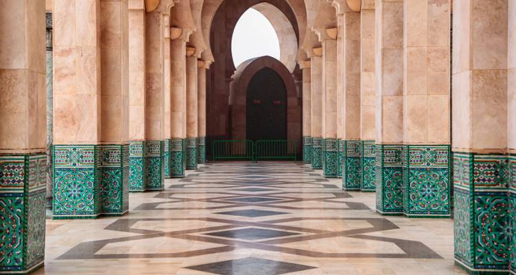 Interior of a mosque with ornate columns and arches.
