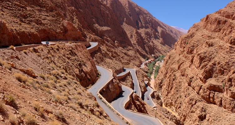 Winding road through reddish canyon.