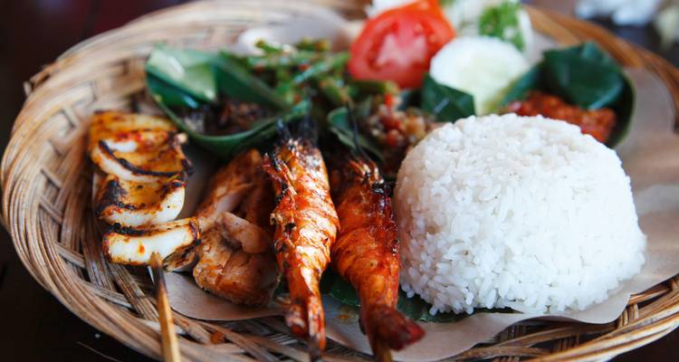 Exquisite platter of grilled seafood served with rice and vegetables.