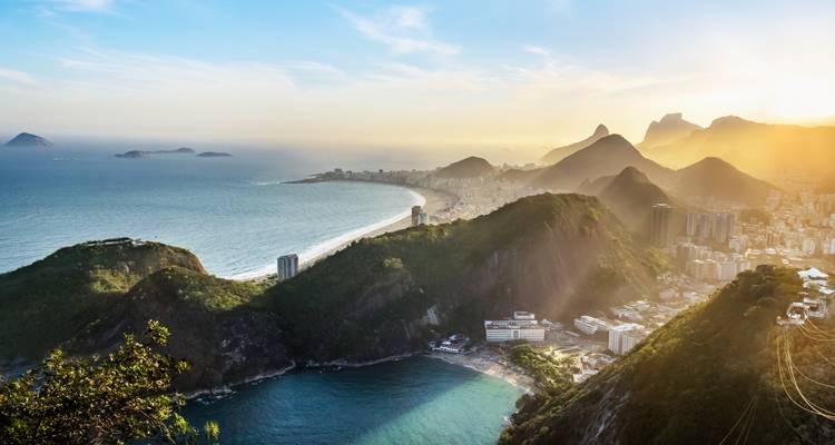 Luchtfoto van een kuststad met beroemde stranden en heuvels.