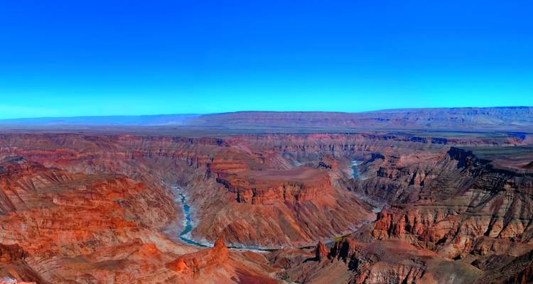 Expansive view of a canyon with a river.