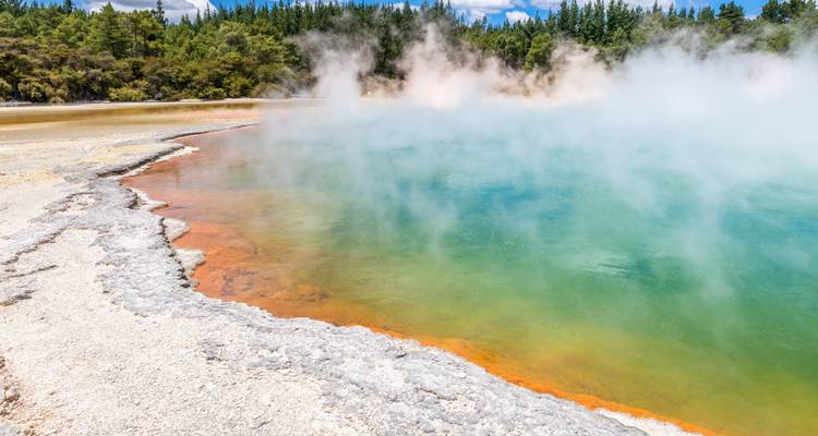 Farbige geothermale Heißwasserquelle mit Dampf.