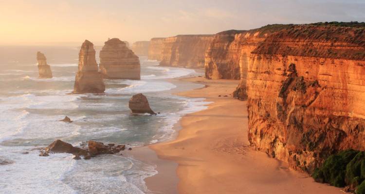 Coastal cliffs at sunset with eroded formations.