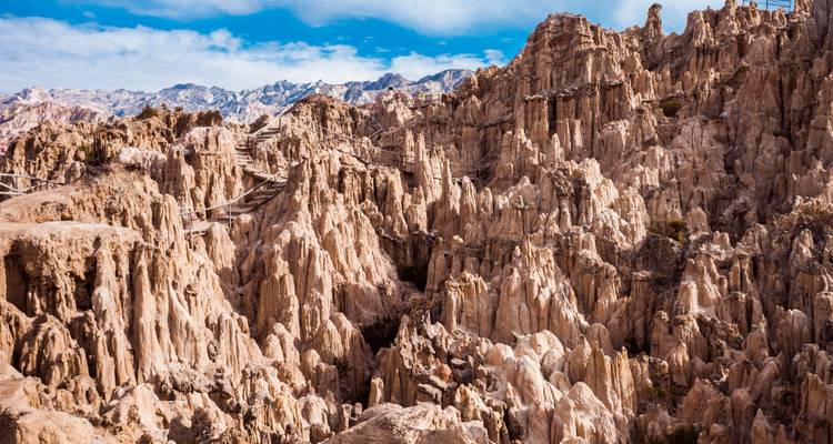 Dramatic eroded rock spires and gullies under a blue sky in the Atacama Desert region