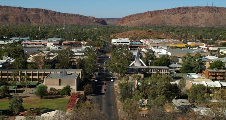 Aerial view of a town surrounded by dry hills and landscape.