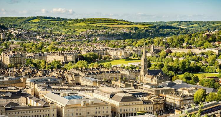 Panoramic view of Bath cityscape with green hills.