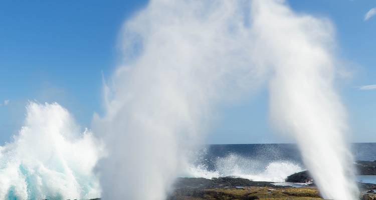 Ocean waves creating a powerful water spout.