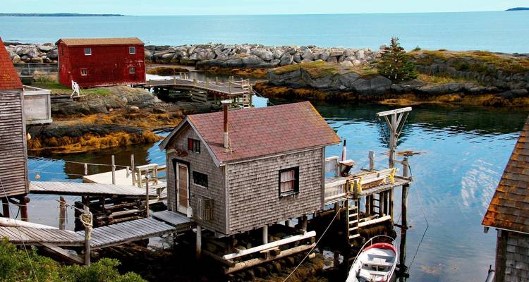 Charming seaside homes and fishing huts on a rocky shoreline.