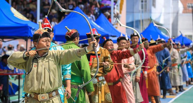 Archers in traditional attire participating in a cultural event.