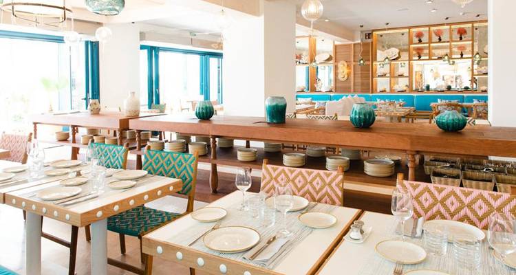 A stylish dining area with modern decor and pastel colors.