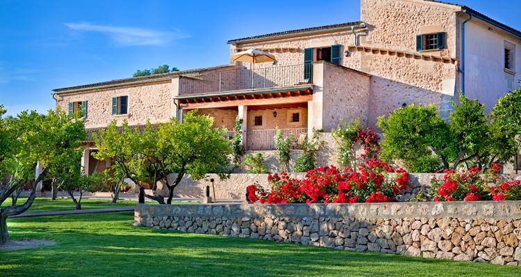 A traditional Mediterranean house with a vibrant garden.