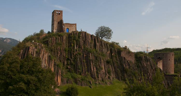 A historic castle ruin on a rocky hilltop.