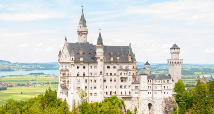 The Neuschwanstein Castle amid a lush landscape.