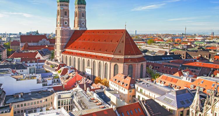 View of a large cathedral amidst urban buildings.