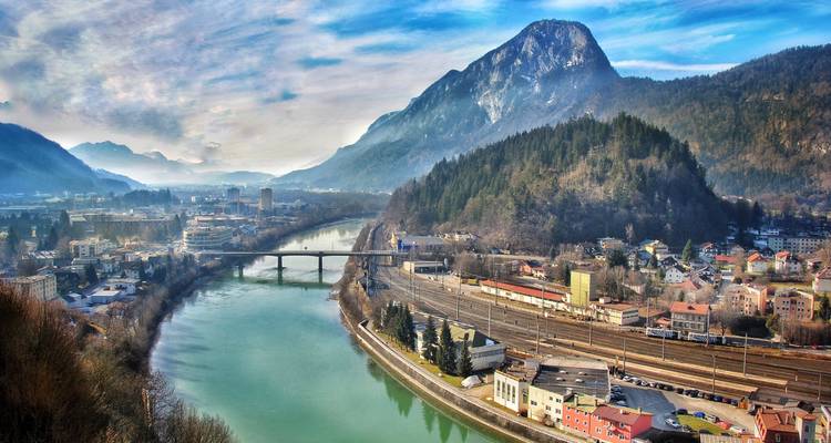 Panoramic view of Kufstein with a river and mountains.