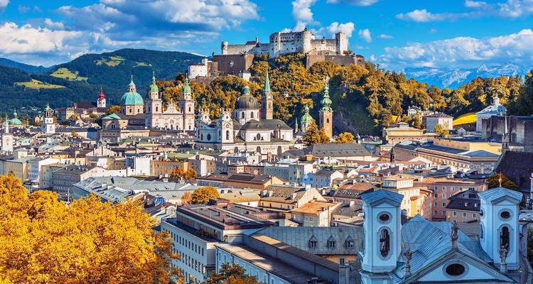 Architectural cityscape with a historic fortress and colorful trees