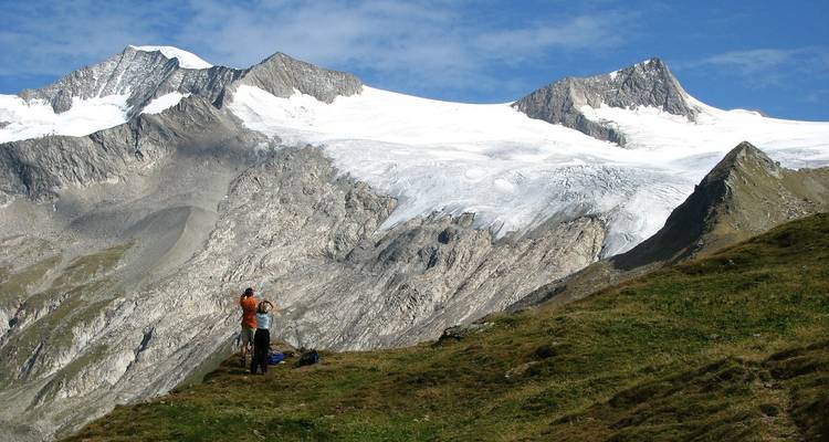 Hikers on a mountainous terrain with glaciers