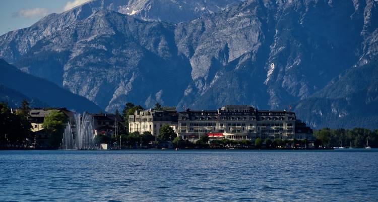 Hotel by a lake with mountains in the background