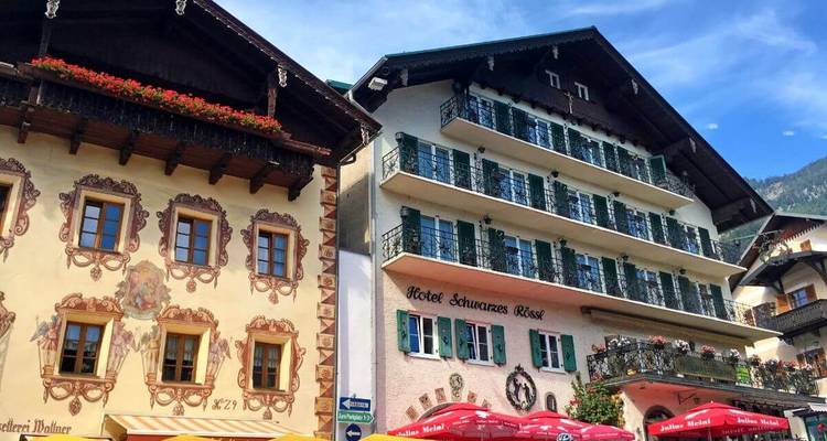 Charming buildings with elaborate facades under blue skies.