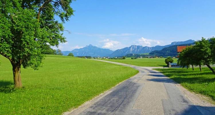 Rural road leading into a mountain landscape.