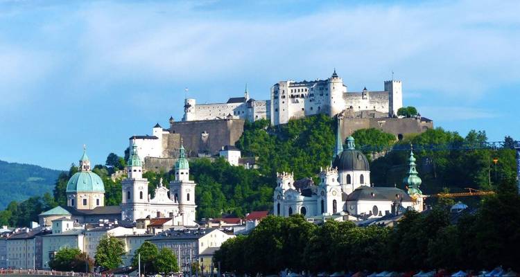 Historisch stadsgezicht met een fort op een heuvel.