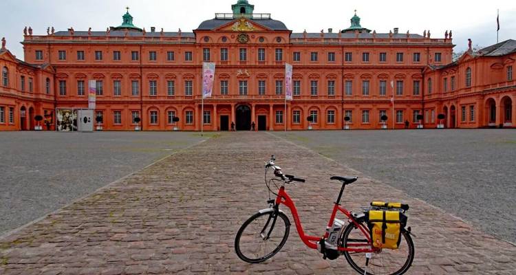 A historic building with a bicycle parked in front.