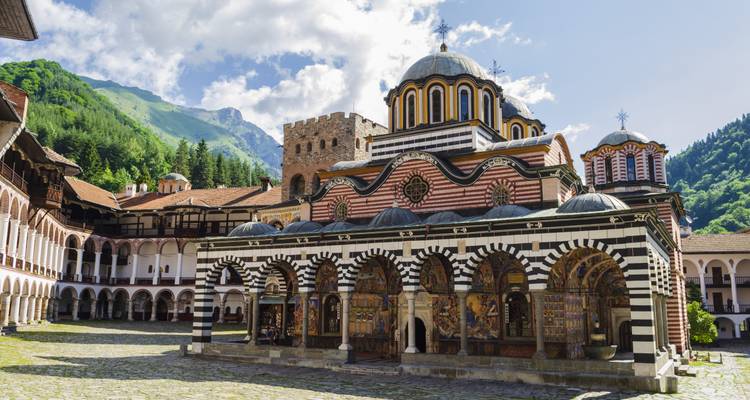 Rila Monastery with intricate architecture surrounded by mountains.