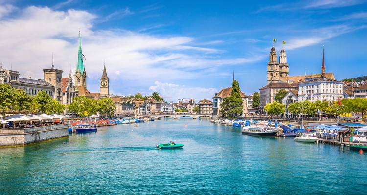 Zurich seen from the water's edge with historical edifices lining the banks.