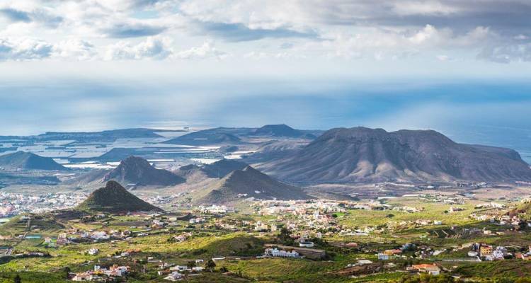 Aerial view of a landscape with hills and ocean.