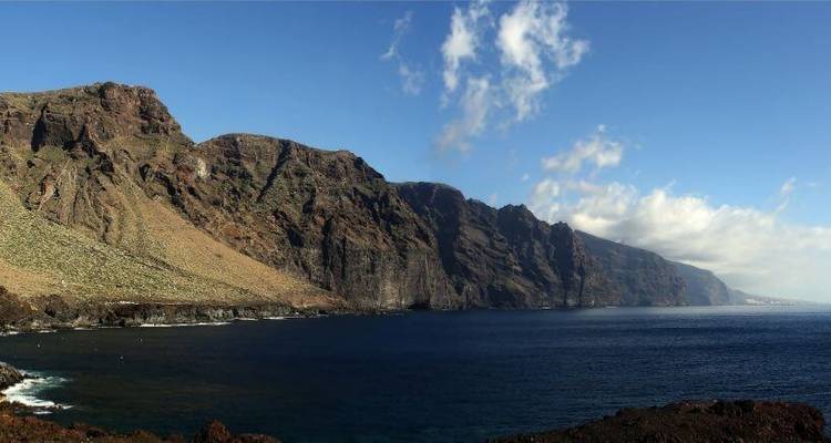Coastal cliffs with a clear blue sea.