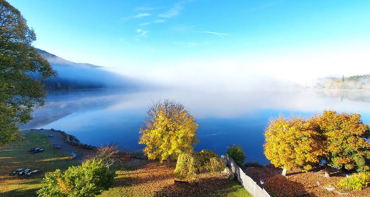 Foggy lake with colorful autumn foliage