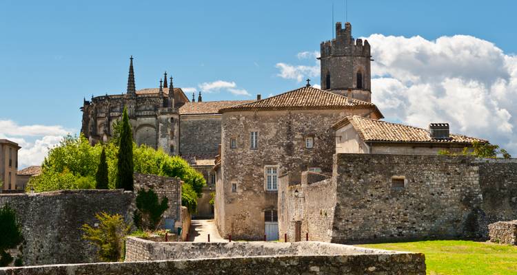 Historic stone buildings with a clear blue sky.