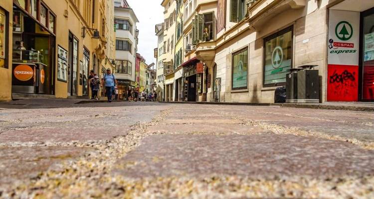 City street with people and old buildings.