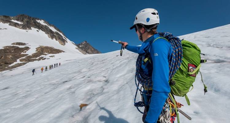 Climbers ascending a snow-covered mountain.