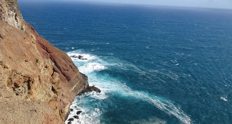 Rocky cliffside with strong ocean waves.