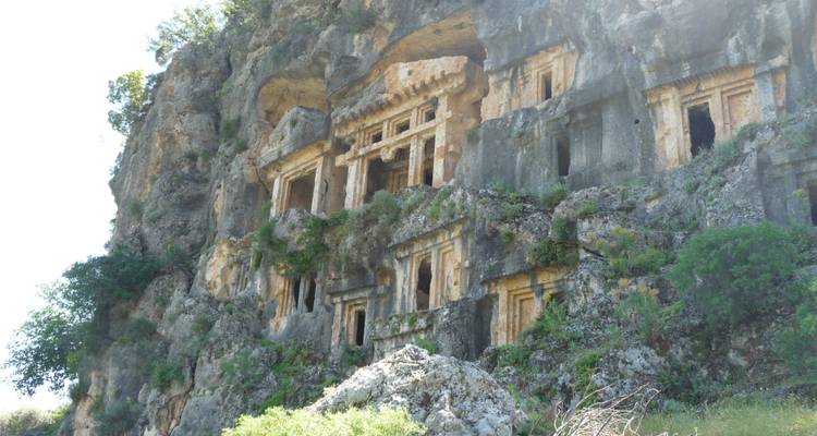 Cliffside ruins with intricately carved stone friezes.