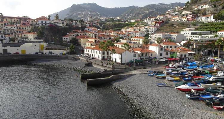 Beach with small boats and a view of the village.